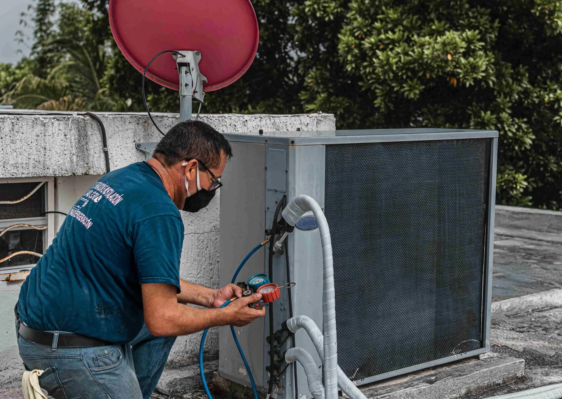 Technician checking outdoor heating and cooling equipment